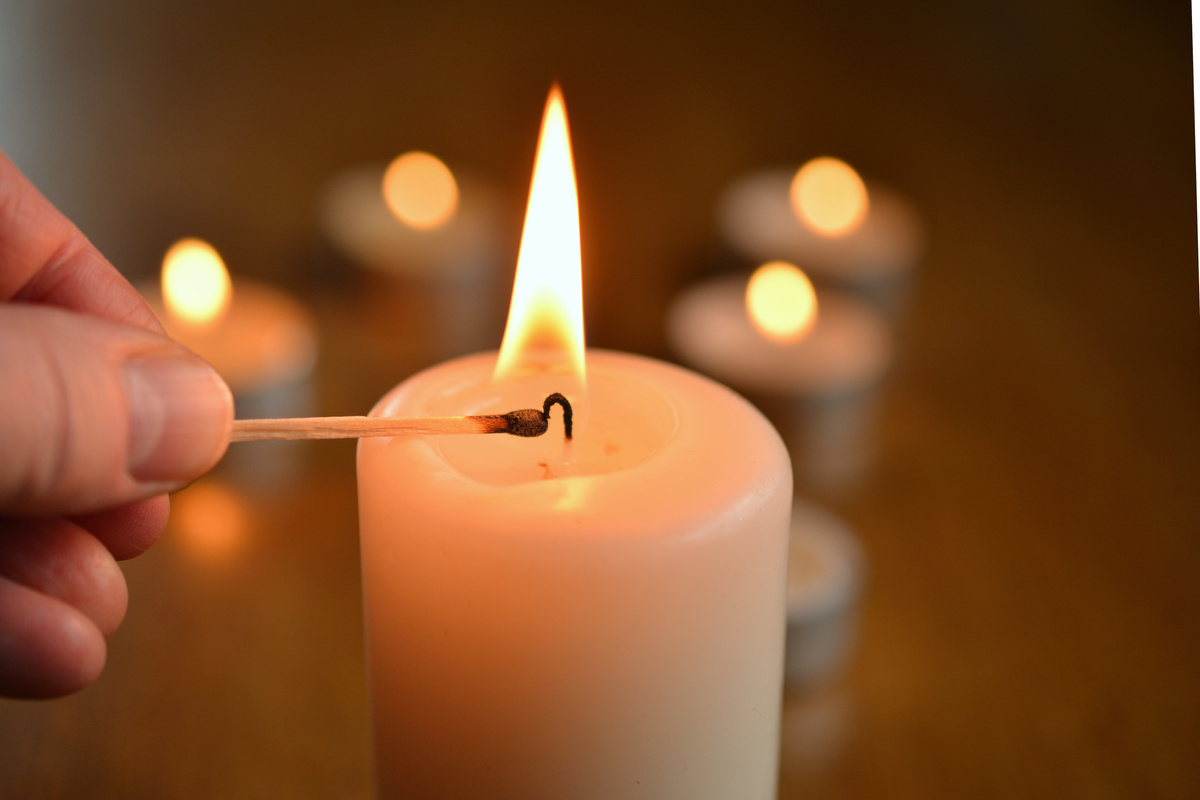 Hand Lighting a Candle
